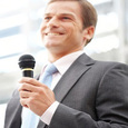 man holding microphone in front of crowd