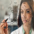 scientist woman writing out formulas on glass