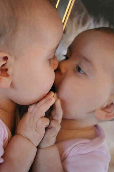 baby playing with mirror