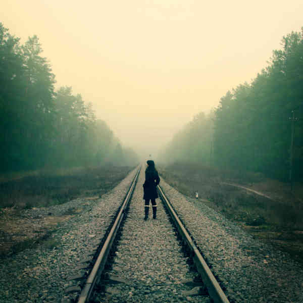 woman standing on train tracks