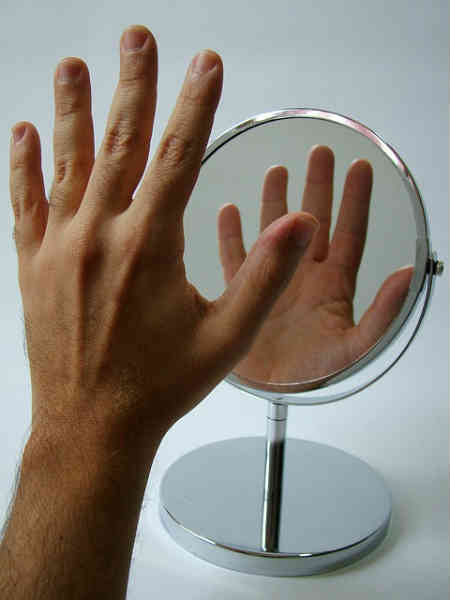 hand in front of a mirror
