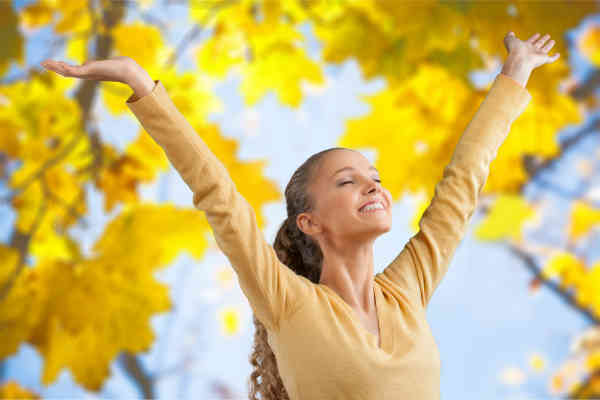happy woman enjoying her day with arms in the air