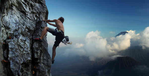 man climbing a mountain
