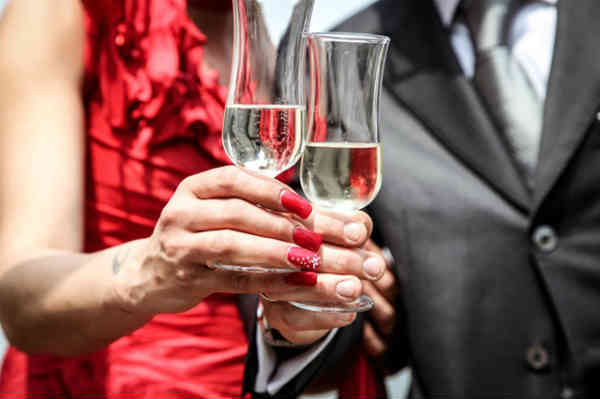 man and woman toasting