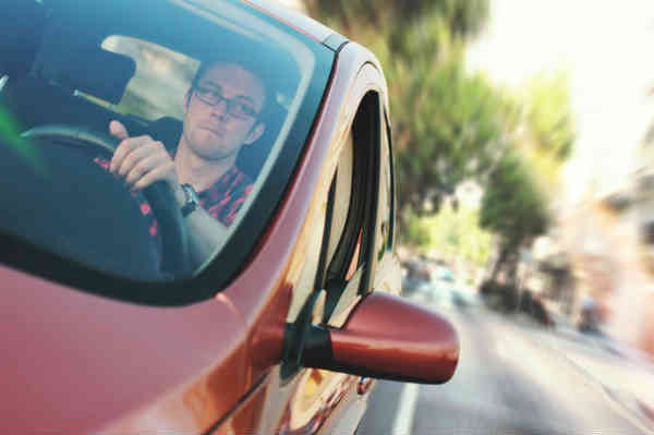 man driving his car