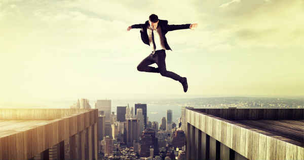 man jumping over a tall building