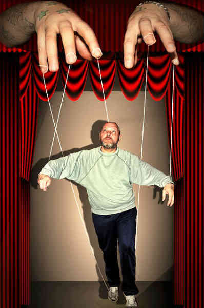 man being pulled by strings