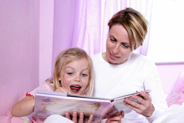 mother reading story to her daughter