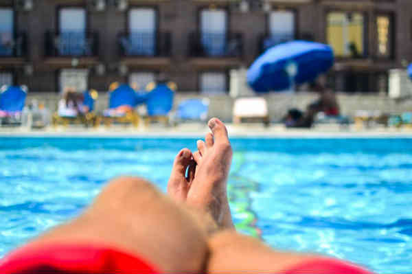 man relaxing at the pool
