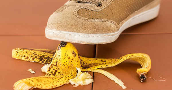 person stepping on a dangerous banana