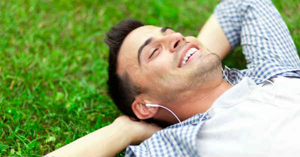 man relaxing on grass stress free