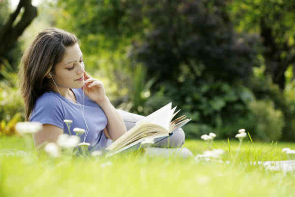 woman reading a book in the park