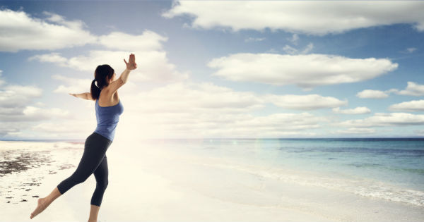 woman dancing on the edge of an ocean