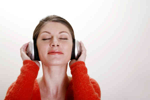 woman happily listening to music on headphoens