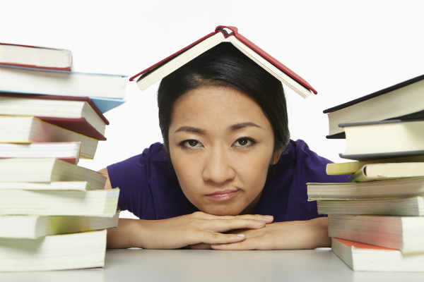woman procrastinating on books