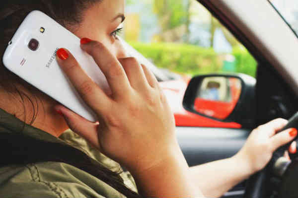 woman talking on a cellphone in a car